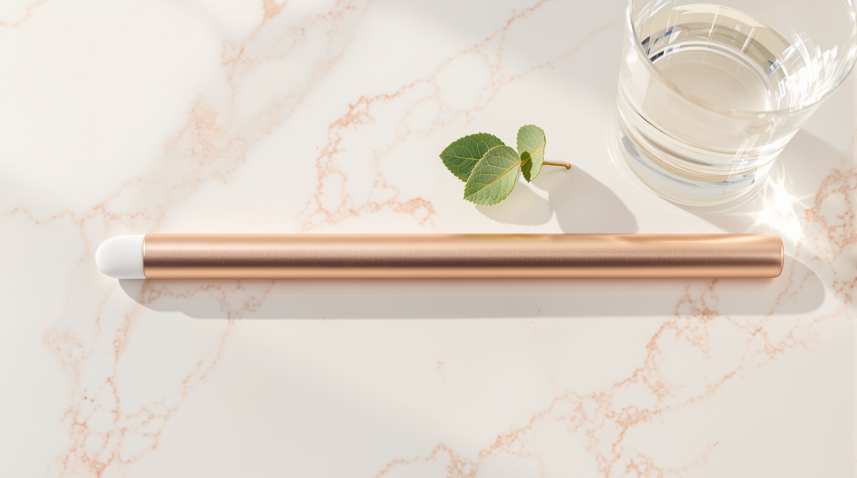 Rose-gold mirtela beauty wand resting on a pale pearl-marble vanity beside fresh myrtle leaves in morning Ligurian light